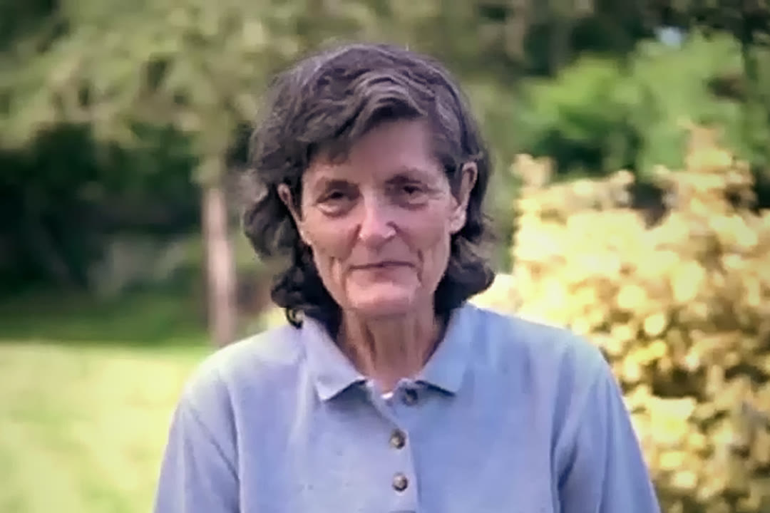 Dr. Elaine Ingham outdoors in front of autumn foliage.